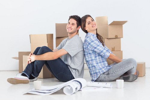 Professional movers handling office equipment